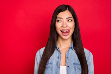 Fototapeta premium Photo of young attractive asian girl happy positive smile lick tongue teeth dream hungry food isolated over red color background