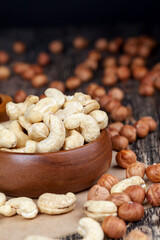 dry cashew nuts, hazelnuts and other dried fruits on an old wooden table