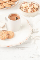 coffee served with variety of cookie and biscuits on table