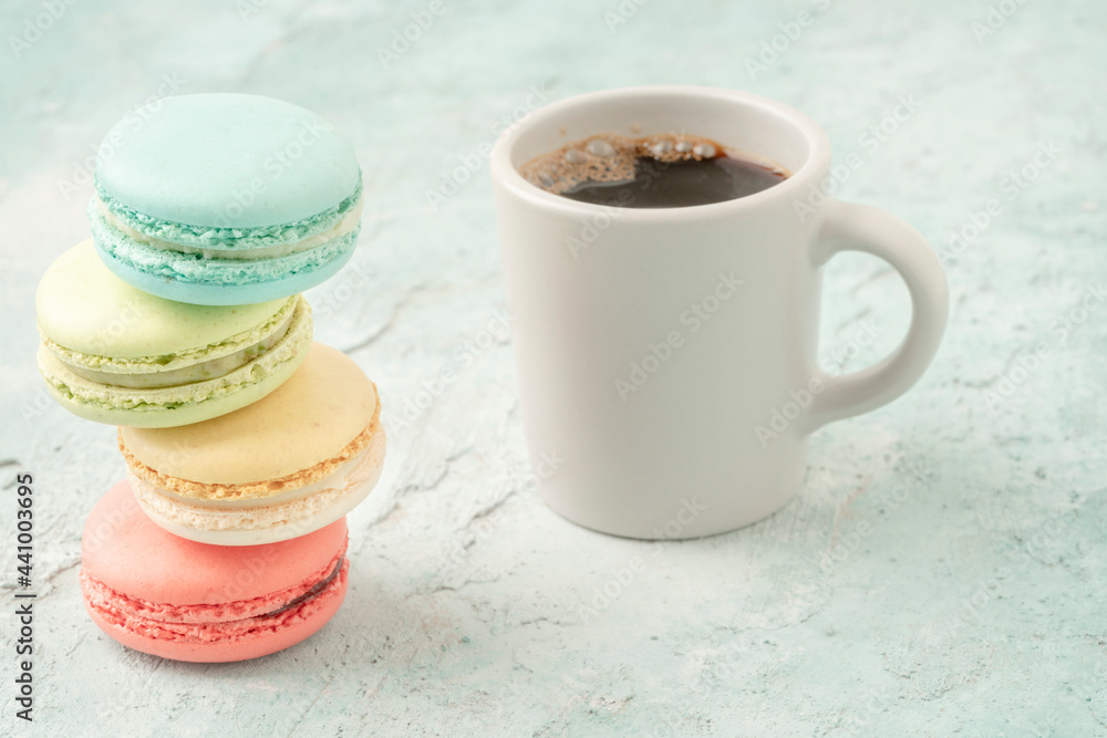 Canvas Prints colorful macaroons and coffee on green background with copy space