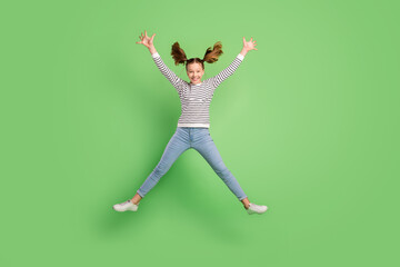 Fototapeta na wymiar Photo of sweet adorable school girl wear white pullover smiling jumping high like star isolated green color background