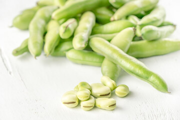 closeup fresh broad bean seeds on a wooden table