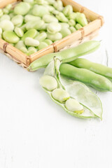 closeup fresh broad bean seeds on a wooden table