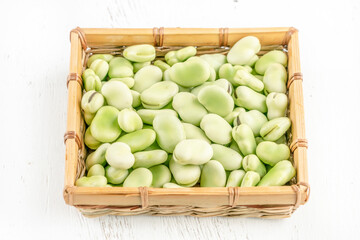 closeup fresh broad bean seeds on a wooden table