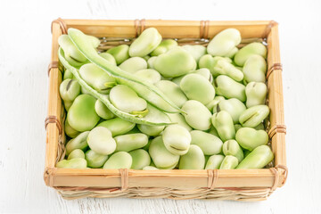 closeup fresh broad bean seeds on a wooden table