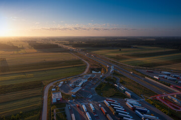 Sun just rises over the highway. Aerial view from the rest area.