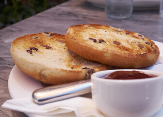 Close up low angle view of toasted teacakes which is a traditional British bun containing raisins...