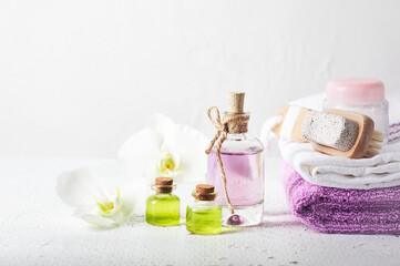 Fototapeta na wymiar Perfume bottle, oil and orchid flowers.