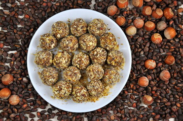Homemade fruit and nut candies on a white plate.
