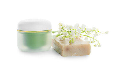 Jar of cream, soap and lily-of-the-valley flowers on white background