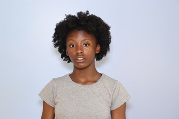 Black Teenage girl close up with acne indoors white background