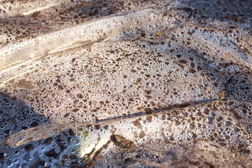A transparent polyethylene sheet on ground for solarisation of the soil to reduce weeds, insects...