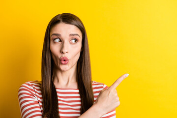 Portrait of attractive amazed girl demonstrating copy space advert pout lips solution isolated over bright yellow color background