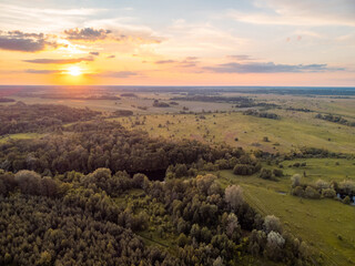 Fototapeta na wymiar Calm landscape of forests and fields during the sunset. Rural landscape made with a drone