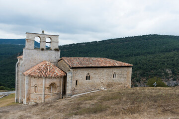 Fototapeta premium Beautiful view of the church dedicated to San Pantaleon de Losa and green hills behind. Burgos, Merindades, Spain, Europe