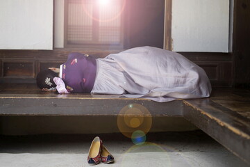 Woman in Korean traditional clothes lying on floor