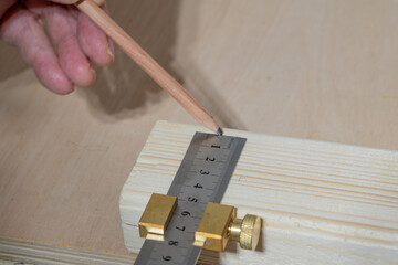 Selective focus close up of a traditional carpenters brass stop and stainless steel measuring and...
