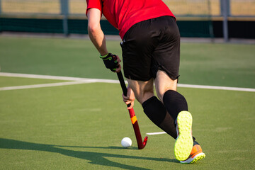 Field hockey player on artificial grass play field.