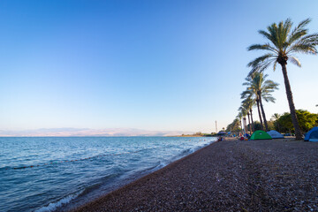 kineret-israel. 18-06-2021. Tents of hikers on the shores of the Sea of Galilee at sunrise, on Korsi beach