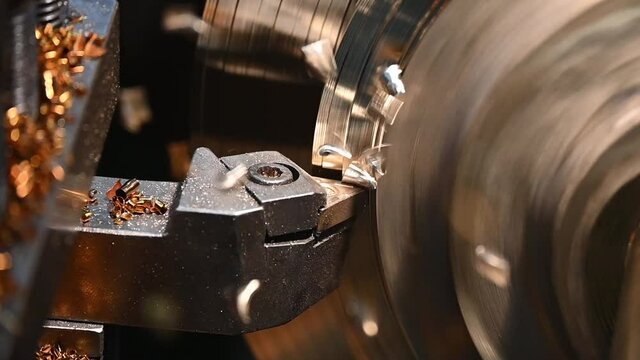 The slow motion scene of lathe machine finishing cut process the brass shaft material. The metalworking process by turning machine.