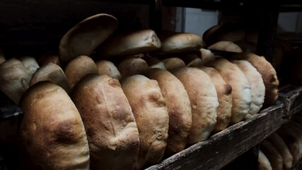 A lot of bread prepare to move on in the shelf. Bakery packaging bread for delivery. Production of bakery products. Bread baking factory. Bread bakery. Food process. Bakery industry. 4k