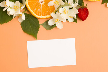 Blank business card or invitation and citrus and strawberry slices with garden jasmine flowers with...