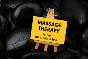 Massage Therapy for your body, mind and soul sign with stones