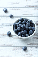 Bilberries on bright wooden background. Close up. Copy space.	