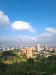 Fototapeta na wymiar Medellin, Antioquia, Colombia. January 14, 2021: landscape with mountains and blue sky. Architecture and facade of buildings in the city