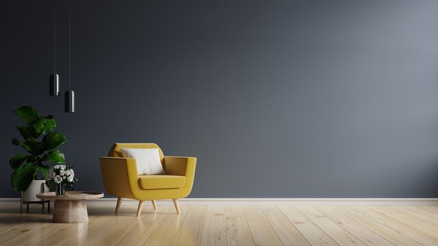 Yellow armchair and a wooden table in living room interior with plant,dark blue wall.