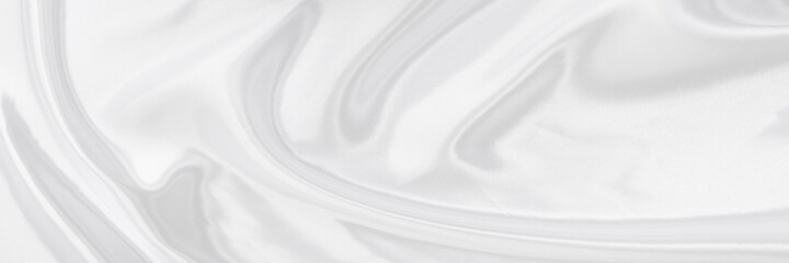 White gray satin texture that is white silver fabric silk panorama background with beautiful soft blur pattern natural.