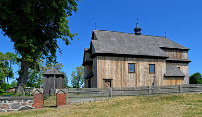 The belfry built in 1792 with the church of St. John the Baptist in the village of Gąsiorowo in Masovia, Poland. The photos show a general view and architectural details of the temple and belfry.