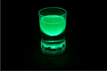 drink in a transparent glass with green backlight