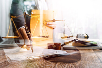 Business and lawyers discussing contract papers with brass scale on desk in office. Law, legal services, advice, justice and law concept picture with film grain effect