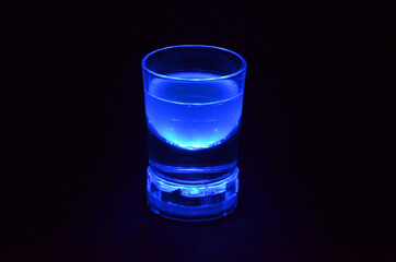 blue glowing drink in a glass