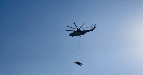The world's largest cargo helicopter hovers overhead. Bottom view.The world's largest cargo...