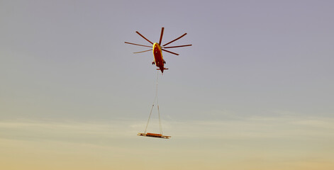 The world's largest cargo helicopter hovers overhead. Bottom view.The world's largest cargo...