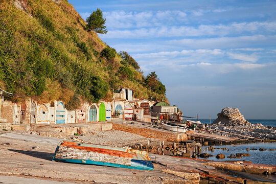 Ancona, Marche, Italy: the metropolitan beach of Passetto with the colorful doors of the caves carved into the rock to shelter the fishing boats