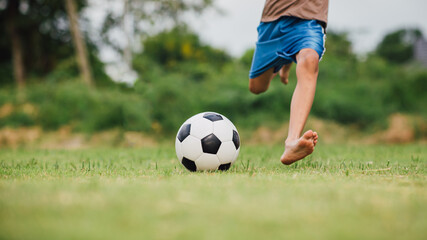 action sport outdoors of diversity of kids having fun playing soccer football for exercise in community rural area under the twilight sunset sky