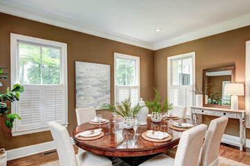 Spacious dining room interior with tasteful furniture.
