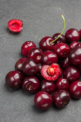 Heap of ripe cherries. Half cherry, pulp and  kernel of cherry