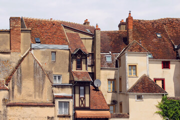 Beautiful old houses with tile roofs in a popular tourist destination, old medieval European city in France, Auxerre in Bourgogne region.