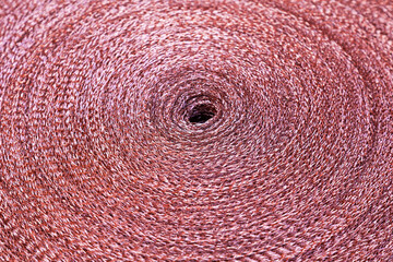Copper mesh, twisted into a roll, top view.