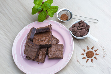 brownie pieces arranged on a plate of black polka dots on a wooden base viewed from above