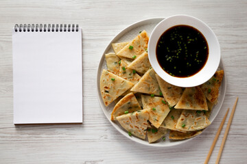 Homemade Scallion Pancakes with Soy Dipping Sauce on a white wooden surface, top view. Flat lay, overhead, from above.