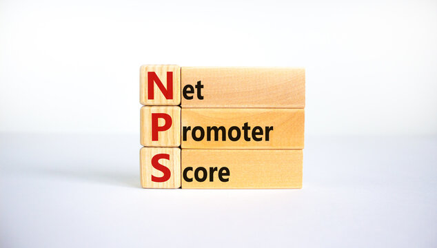 NPS net promoter score symbol. Wooden blocks with words 'NPS net promoter score'. Beautiful white background. Business and NPS net promoter score concept. Copy space.