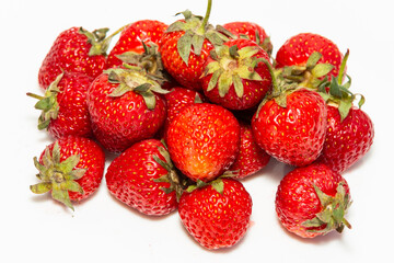 Harvest of fresh ripe strawberries on a white background. Close-up. Healthy eating.