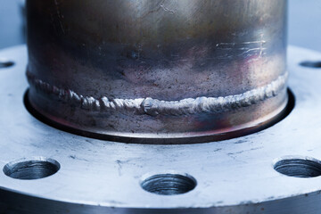 Steel pipe with weld seam and quick-release flange on the pipe, close-up.