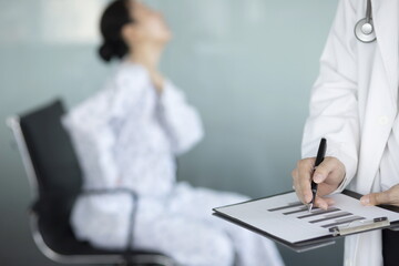 Fototapeta premium Close up of doctor writing on clipboard