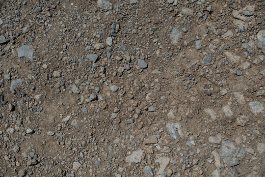 Stony Desert Soil Texture. Gray Dry Ground With Small Stones. Close-up From Above